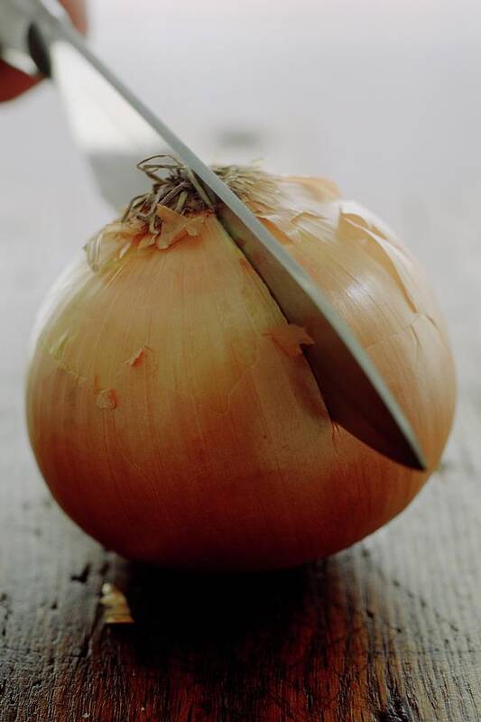 Fruits Art Print featuring the photograph A Raw Onion Being Cut In Half by Romulo Yanes