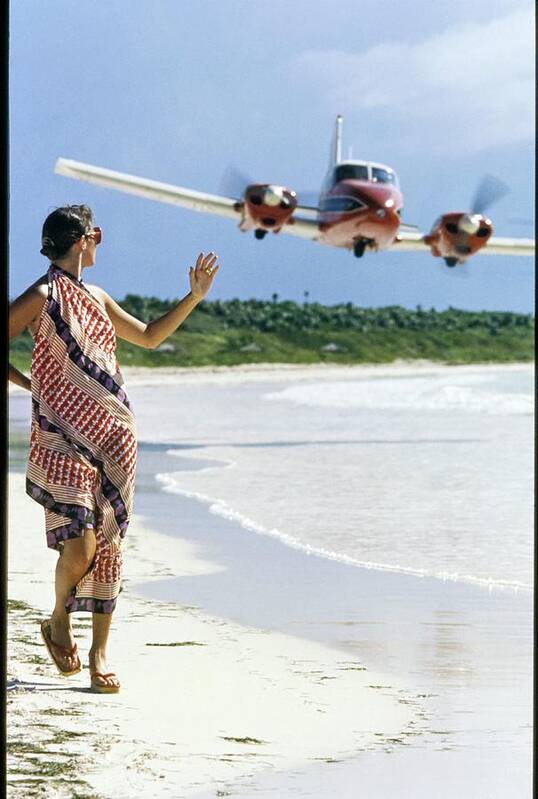 Caribbean Model Beach Airplane Bahamas Atlantic Islands Out Islands 1970s Style Outdoors Daytime One Person People Fashion Model Clothing 20-24 Years Young Adult 20s Adult Woman Young Woman Young Adult Woman Brunette Dark Hair Dress Sand Sea Water Transportation Travel Aircraft Passenger Plane Commercial Airplane Aviation Jet Plane Flying Waving Looking Over Shoulder Walking Scarf Dress Lanvin Flip Flops Footwear Sunglasses Eyewear Overcast Overcast Sky Selective Focus #condenastvoguephotograph #condenastvoguephotograph December 1st 1972 Art Print featuring the photograph Model Wearing A Lanvin Dress by Kourken Pakchanian