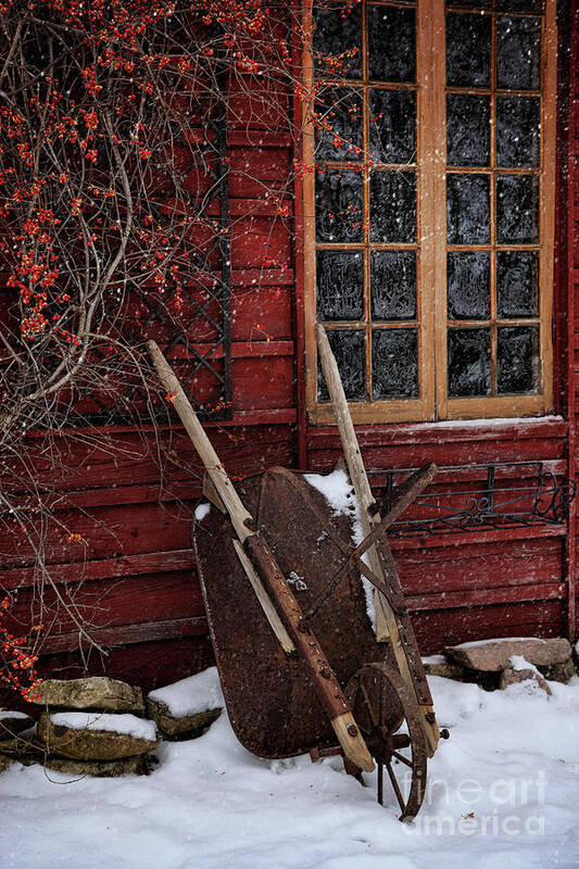 Atmosphere Art Print featuring the photograph Old wheelbarrow leaning against barn in winter by Sandra Cunningham