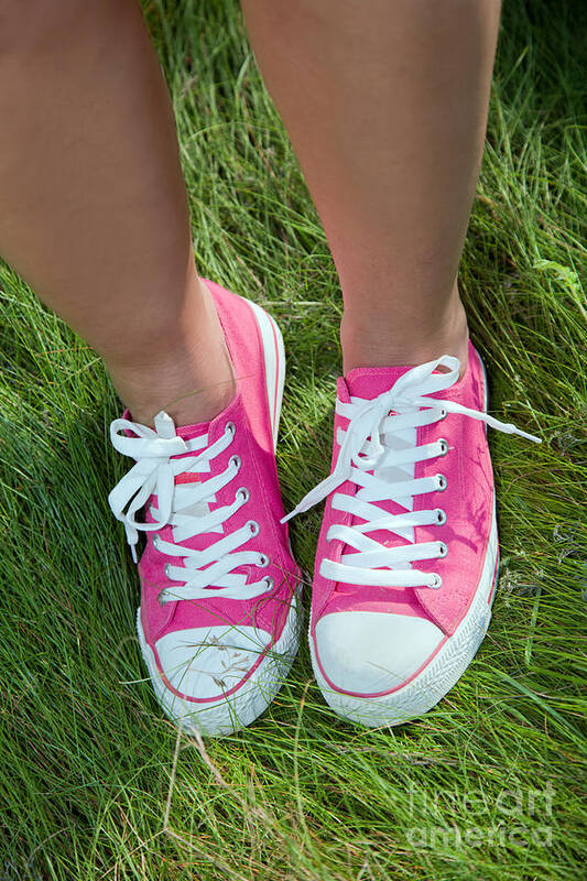 Grass Art Print featuring the photograph Pink sneakers on girl legs on grass by Michal Bednarek