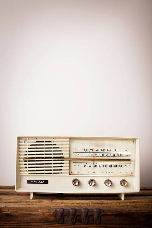 Desaturated Art Print featuring the photograph Vintage Beige Radio Sitting On Wood by Ideabug