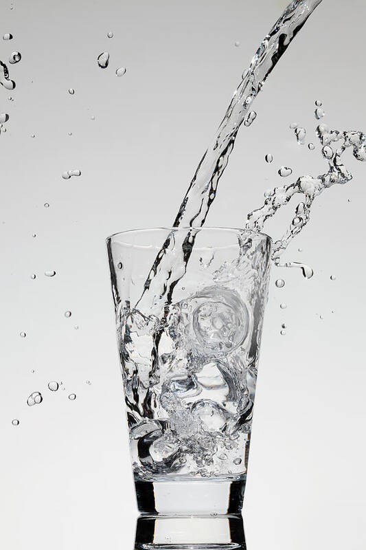 Mid-air Art Print featuring the photograph Water Being Poured Into A Glass by Dual Dual