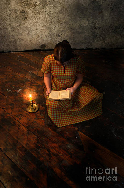 Girl Art Print featuring the photograph Schoolgirl Sitting on Wood Floor Reading by Candlelight by Jill Battaglia