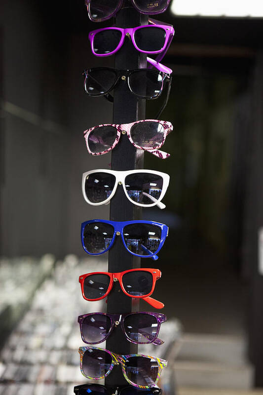 Vertical Art Print featuring the photograph Sunglasses On Display In A Store by Halfdark