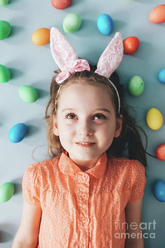 Girl Art Print featuring the photograph Girl with bunny ears surrounded by colorful eggs. by Michal Bednarek