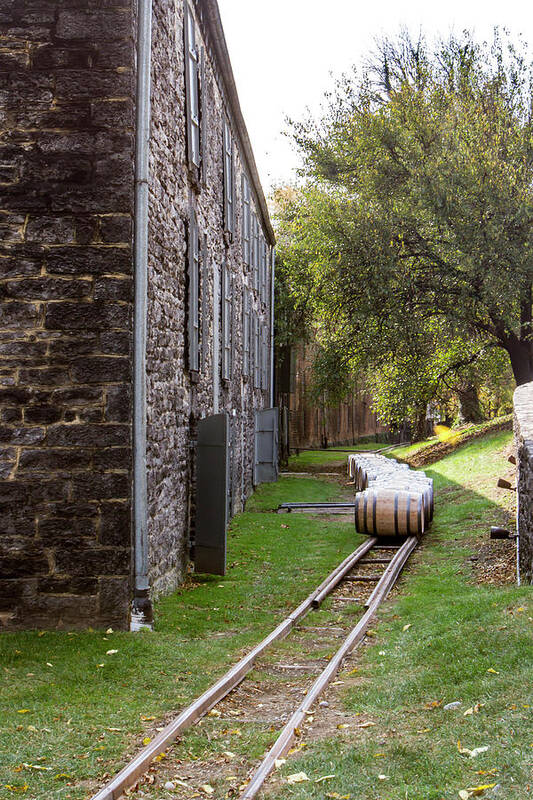 American Art Print featuring the photograph Oak barrels outside stone distillery by Karen Foley