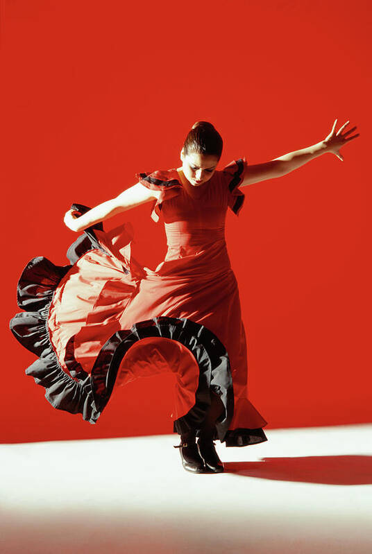Ballet Dancer Art Print featuring the photograph A Female Flamenco Dancer Performing A by George Doyle
