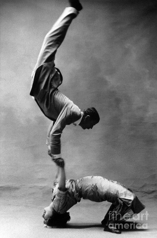 Caucasian Ethnicity Art Print featuring the photograph Acrobats Performing Balancing Act, Side by Vintage Images