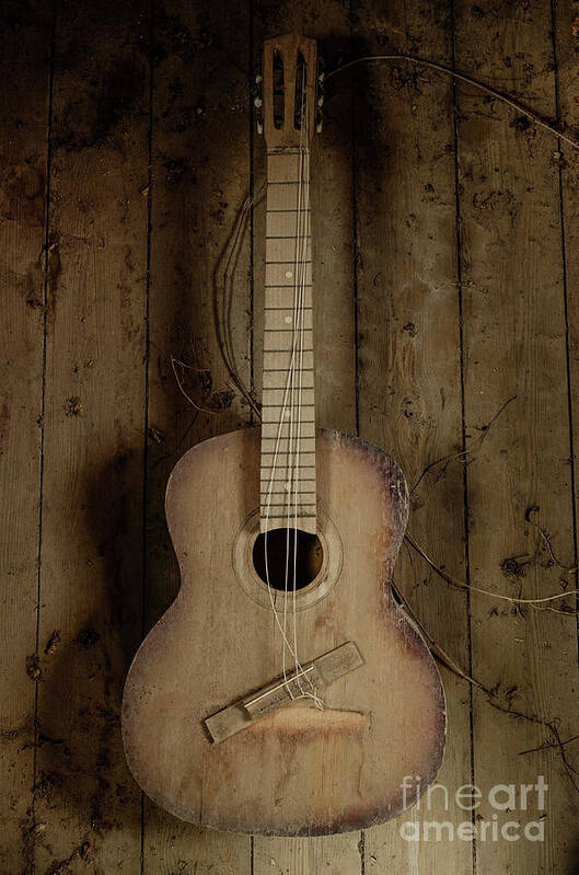 An Old Guitar Art Print featuring the photograph An old guitar by Benny Woodoo