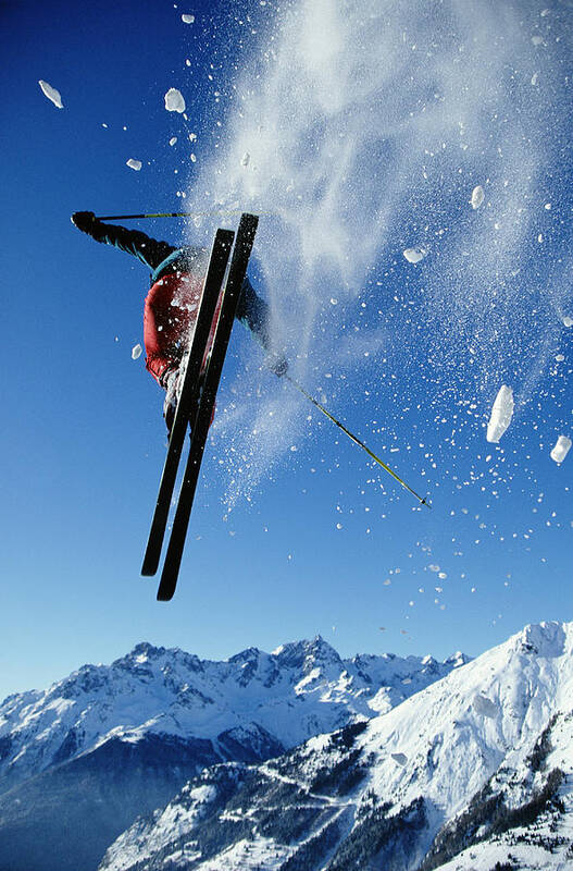 Skiing Art Print featuring the photograph Downhill Skier In Mid-air, Rear View by Ross Woodhall