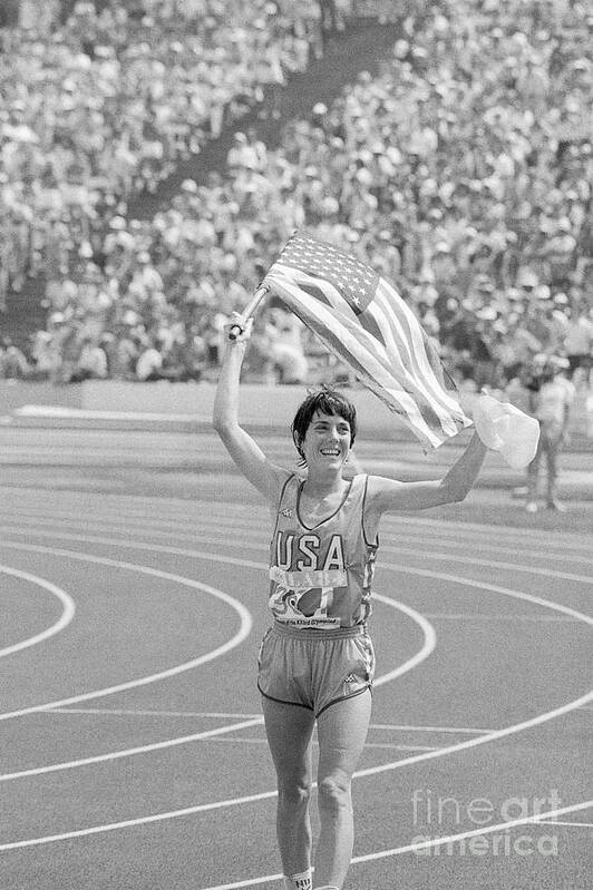 1980-1989 Art Print featuring the photograph Joan Benoit Running With American Flag by Bettmann