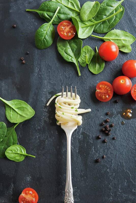 Ip_12313903 Art Print featuring the photograph Linguine On A Fork On A Marble Table, With Tomatoes And Spinach Leaves by Victoria Firmston