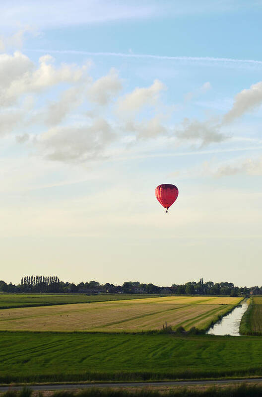 Netherlands Art Print featuring the photograph Red Hot Air Balloon Above Polder Field by Photo By Ira Heuvelman-dobrolyubova