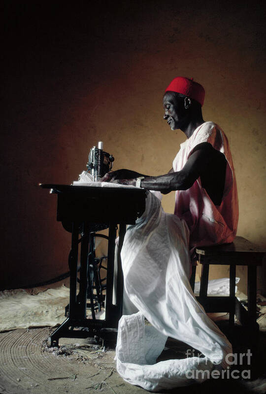Working Art Print featuring the photograph Tailor Using A Sewing Machine by Lawrence Manning