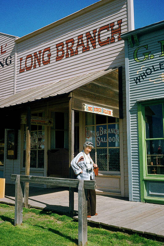 Woman outside a Long Brach saloon bar in Dodge city, Kansas