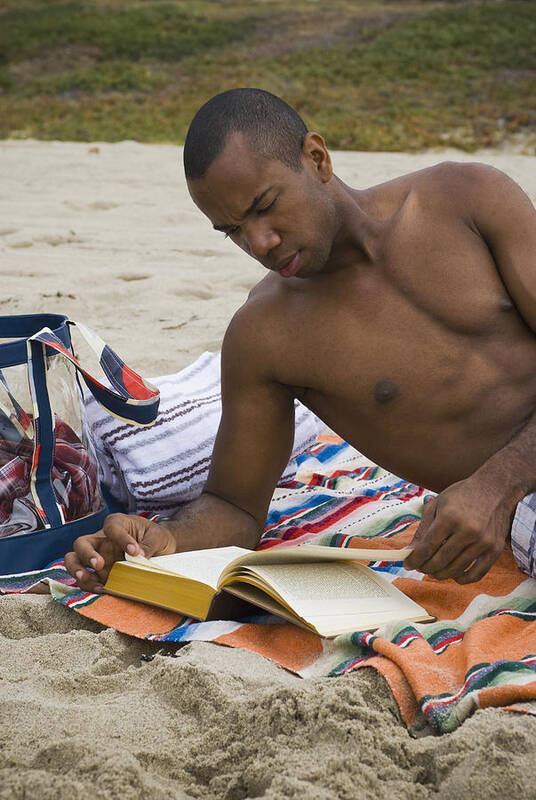 People Art Print featuring the photograph African man reading book on beach by Sam Bloomberg-Rissman
