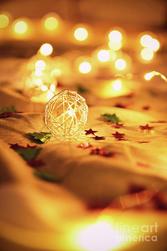 Lights Art Print featuring the photograph Blurred golden Christmas lights with decorations on rumpled bed by Mendelex Photography