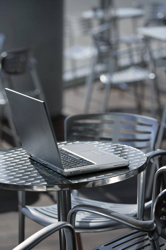 Computer Art Print featuring the photograph Laptop at a cafe by Comstock Images
