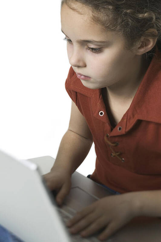 Working Art Print featuring the photograph Medium Shot Of A Young Female Child As She Types On A Laptop Computer by Photodisc