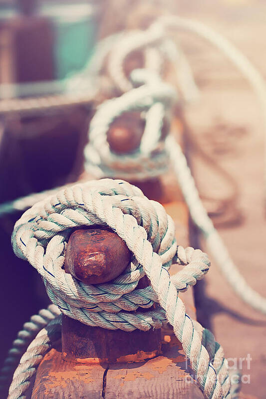 Sea Art Print featuring the photograph Quayside cleats and tied ropes with boats moored in the backgrou by Jane Rix