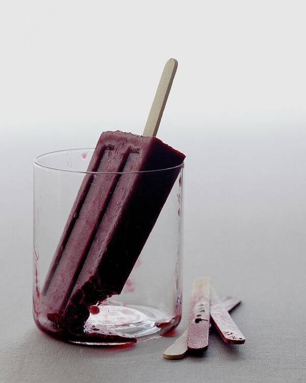 Snack Art Print featuring the photograph A Blueberry Lime Popsicle by Romulo Yanes