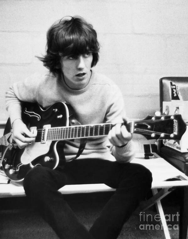 Rock Music Art Print featuring the photograph George Harrison Playing Guitar #1 by Bettmann