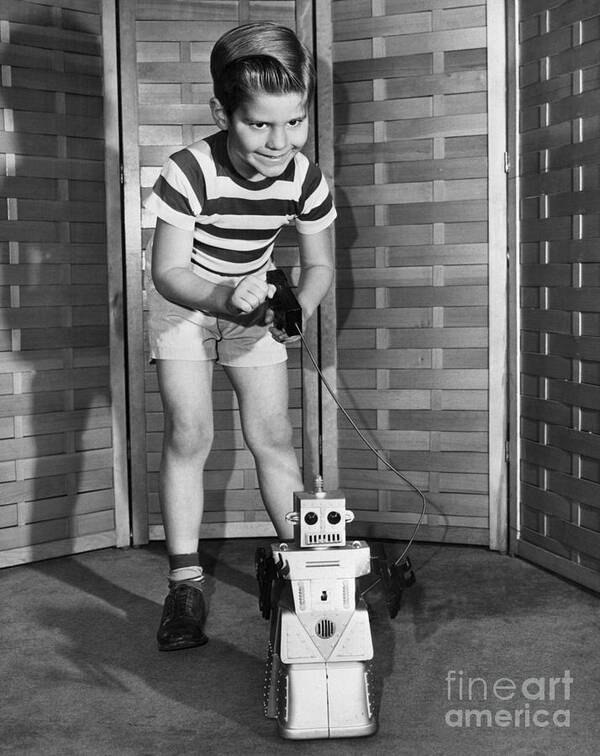Child Art Print featuring the photograph Boy With Remote Control Robot by Bettmann