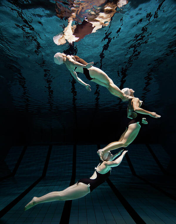 Underwater Art Print featuring the photograph Three Synchronised Swimmers In Formation by Henrik Sorensen