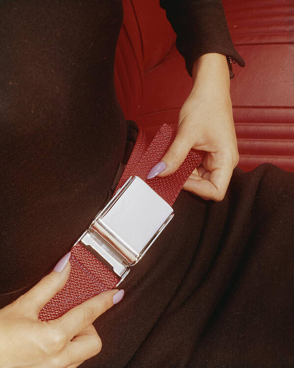 People Art Print featuring the photograph Woman Fastening His Seatbelt, Close-up by Tom Kelley Archive