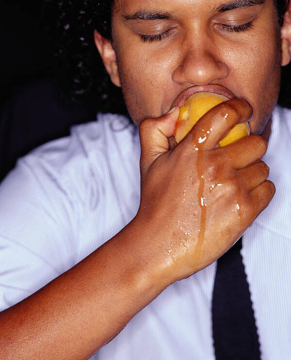Biting Art Print featuring the photograph Businessman biting peach, juice running down hand, close-up by Tom Merton