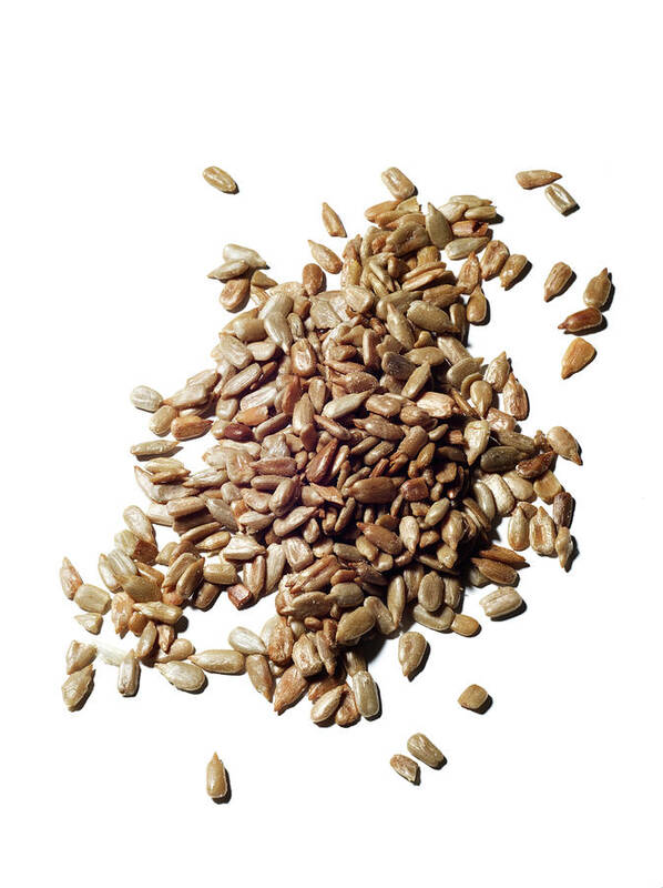 White Background Art Print featuring the photograph A Pile Of Sunflower Seeds by Jonathan Kantor