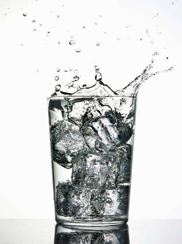 White Background Art Print featuring the photograph Ice Cubes Splashing Into Fizzy Drink by Walter Zerla