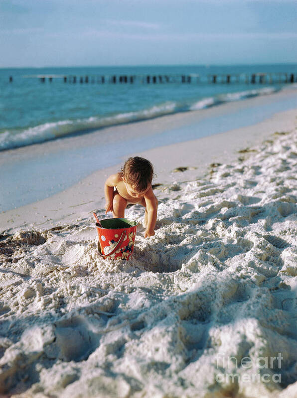 Child Art Print featuring the photograph Little Girl Playing At Beach With Pail by Bettmann