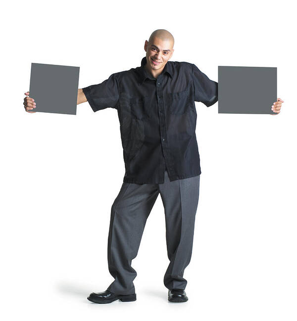 Rectangle Art Print featuring the photograph A Young Hispanic Male Wearing Grey Slacks And A Black Shirt Stretches His Arms Out To Hold Two Blank Signs As He Smiles At The Camera by Photodisc