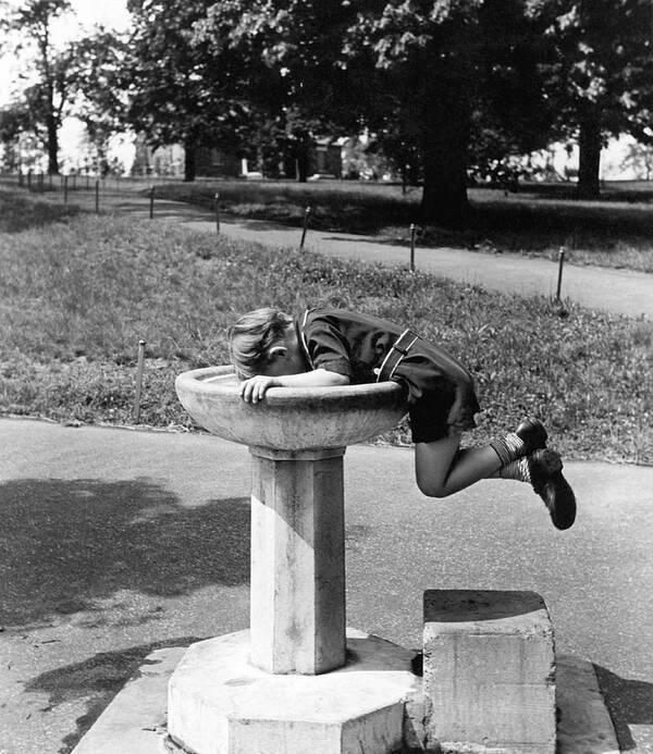 1930's Art Print featuring the photograph Boy Drinking From Fountain by Underwood Archives