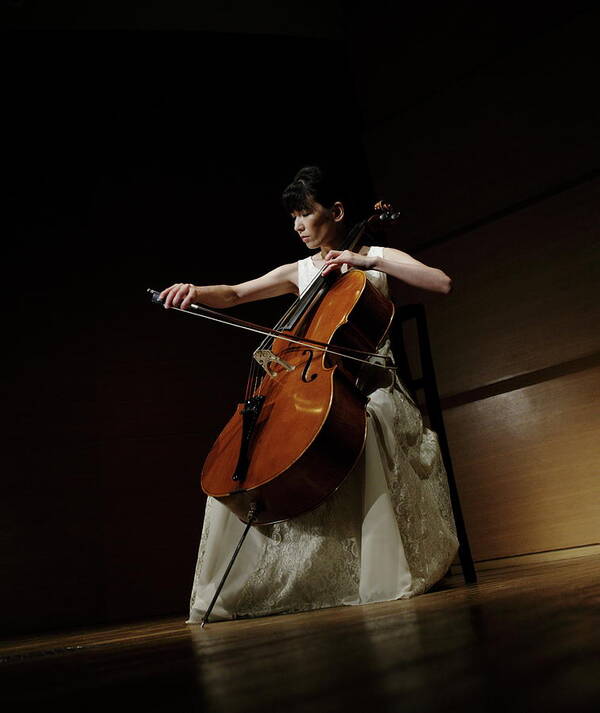 Mature Adult Art Print featuring the photograph A Female Cellist Playing Cello On Stage by Sot