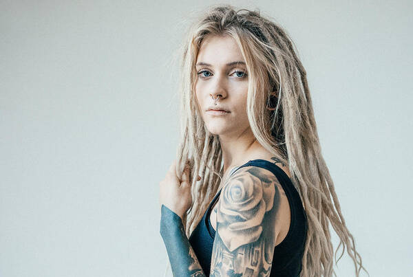 Portrait Of Young Tattooed Women With Blond Dreadlocks Art Print