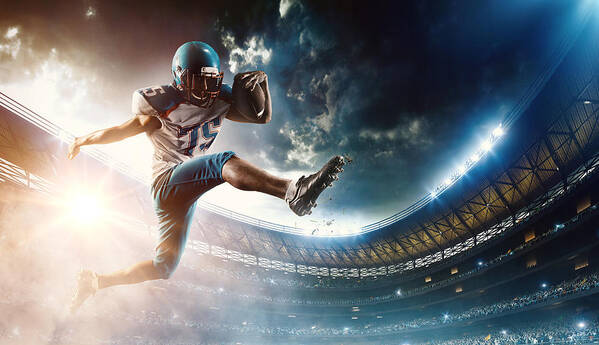 Sports Helmet Art Print featuring the photograph Football player runs with the ball #1 by Dmytro Aksonov
