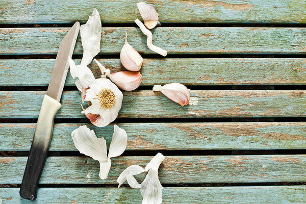 Background Art Print featuring the photograph Cutting garlic #1 by Tom Gowanlock