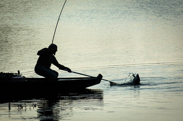 Fish Art Print featuring the photograph Fisherman Catching Fish On A Twilight Lake #1 by Andreas Berthold