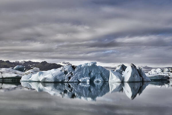 Scenics Art Print featuring the photograph Icebergs floating in the Jokulsalon glacier lagoon in Iceland #1 by Sjo