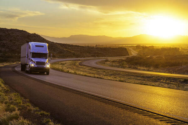Scenics Art Print featuring the photograph 18-wheeler Tractor-trailer Truck On Interstate Highway At Sunset by Dszc