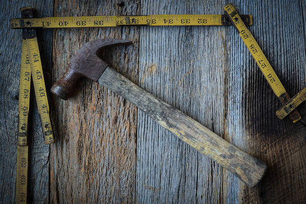 Accuracy Art Print featuring the photograph Old Tape Measure and Hammer for Construction on Rustic Wood Back #2 by Brandon Bourdages
