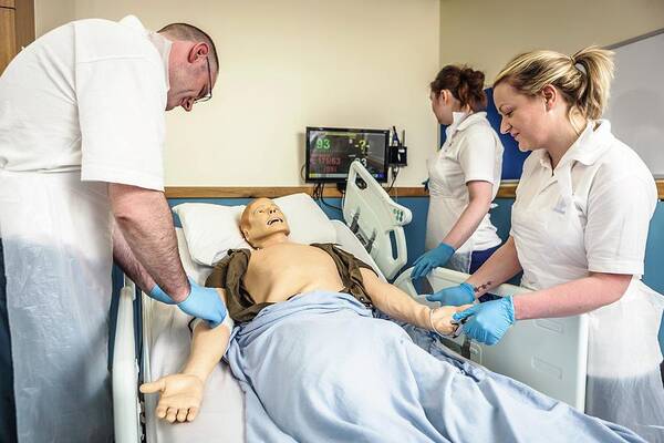 Three People Art Print featuring the photograph Acute Care And Resuscitation Training #3 by Gustoimages