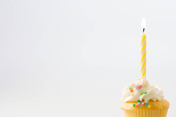 White Background Art Print featuring the photograph Birthday candle on a cup cake by Image Source