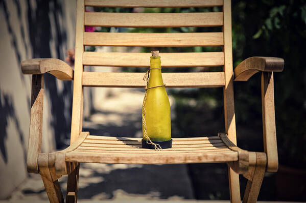 Wooden Art Print featuring the photograph Bottle on wooden chair by Mike Santis