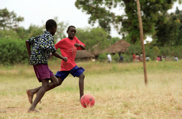Human Art Print featuring the photograph Boys Playing Football by Mauro Fermariello/science Photo Library