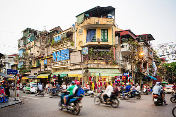 Asian And Indian Ethnicities Art Print featuring the photograph Busy street corner in old town Hanoi Vietnam by NicolasMcComber