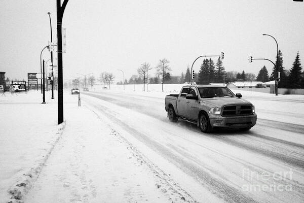 Snow Art Print featuring the photograph cars travelling along 8th street in blizzard conditions Saskatoon Saskatchewan Canada by Joe Fox