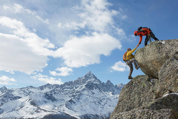 Young Men Art Print featuring the photograph Climber Extends Helping Hand To Teammate by Ascent Xmedia